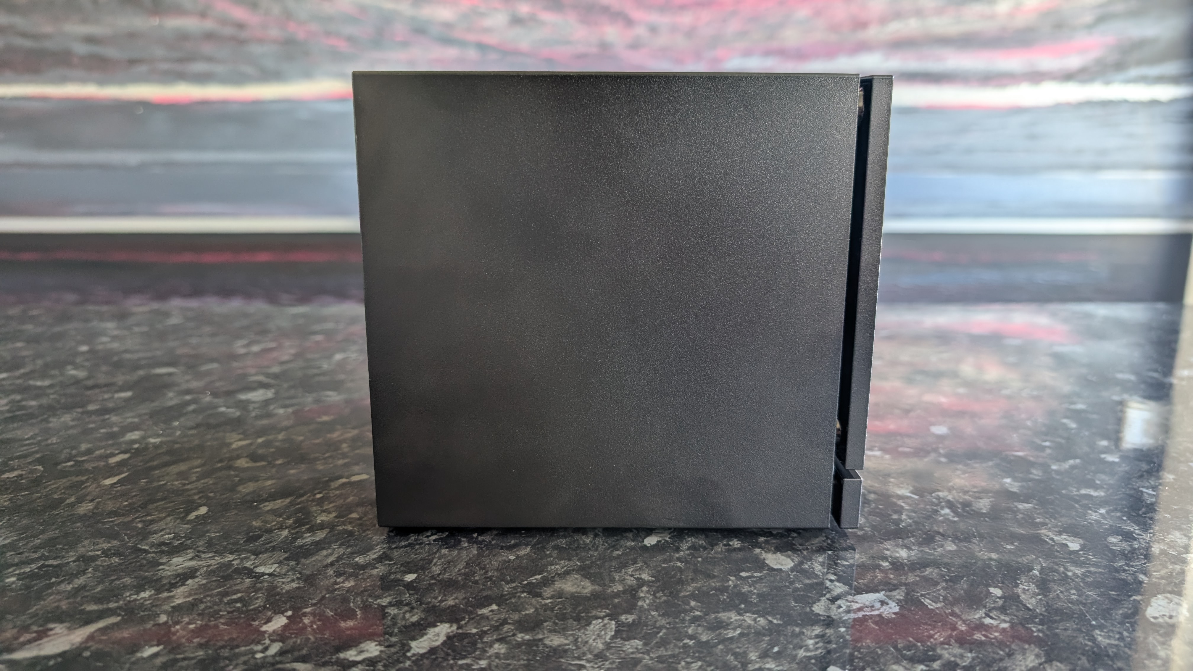 The Valve Steam Machine, pictured on a dark marble worktop.