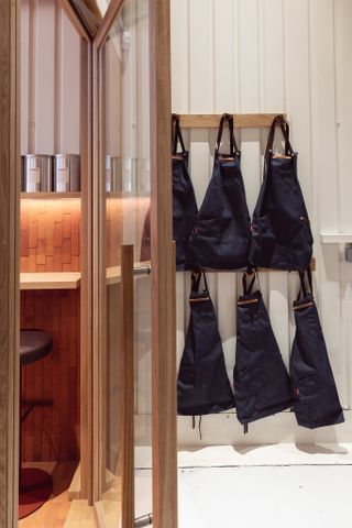 Barisa aprons hanging up on the wall