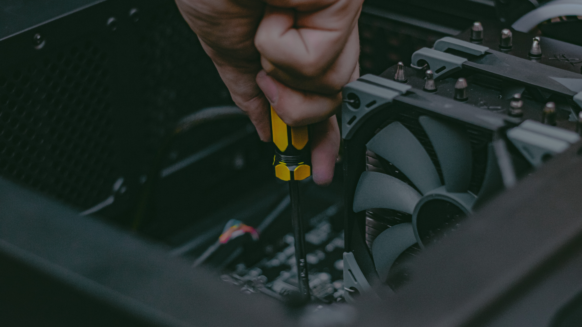 Técnico de informática closeup reparando um PC segurando uma chave de fenda