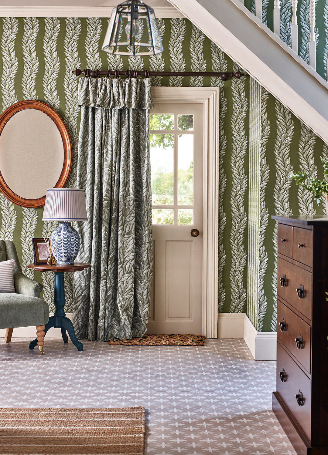 Hallway with matching wallpaper to fabric forming a door curtain over a side door