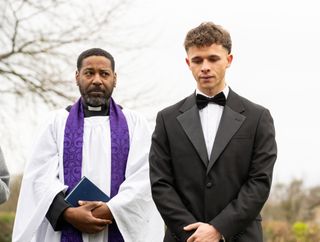 Vicar Charles and Jacob look down at Leyla's grave in Emmerdale