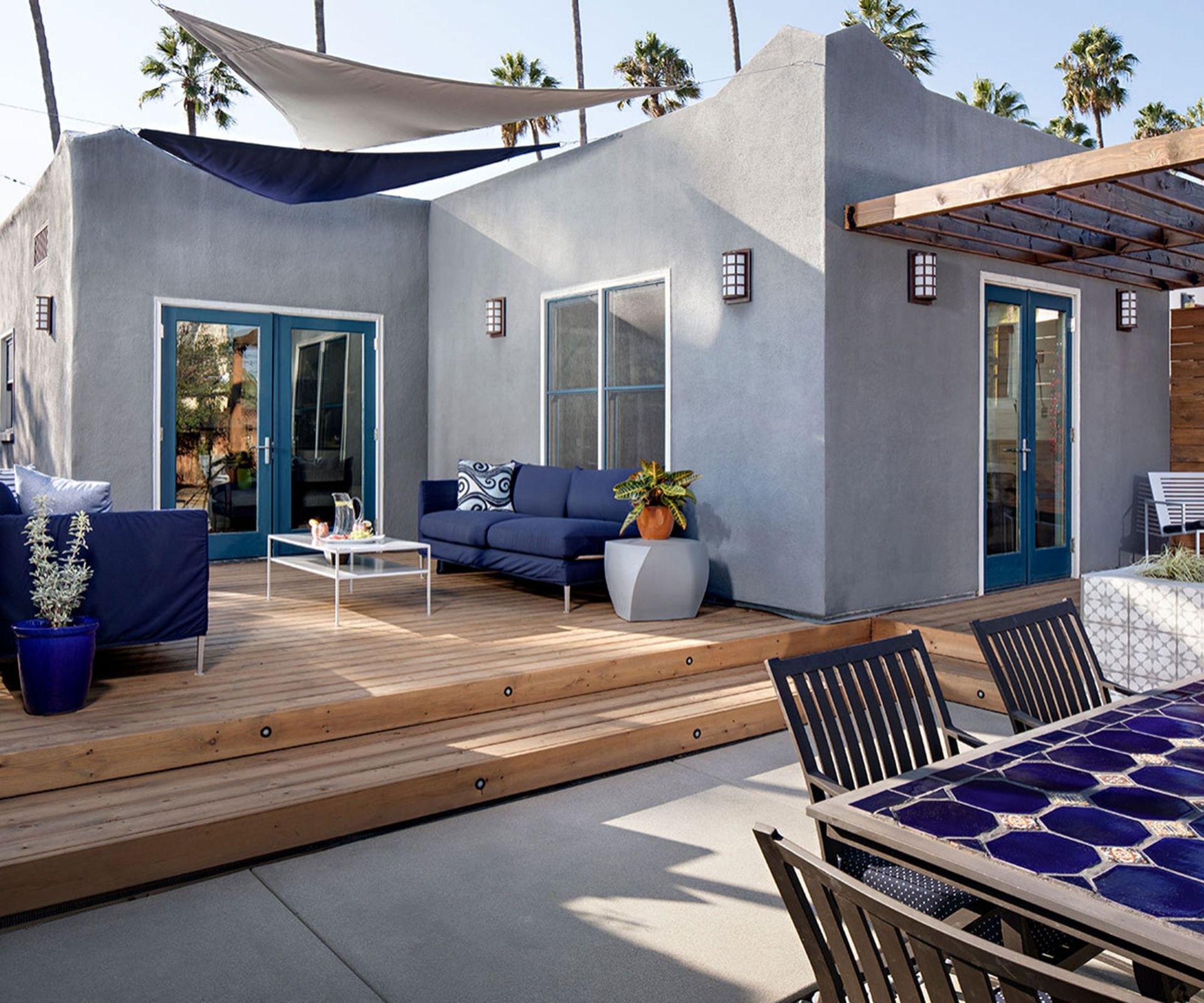 split level deck and patio space with sail shade and pergola