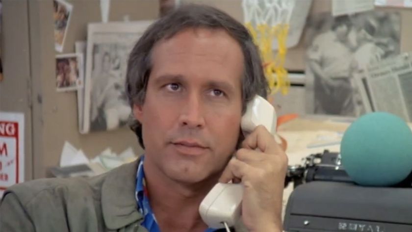 Chevy Chase holding a telphone