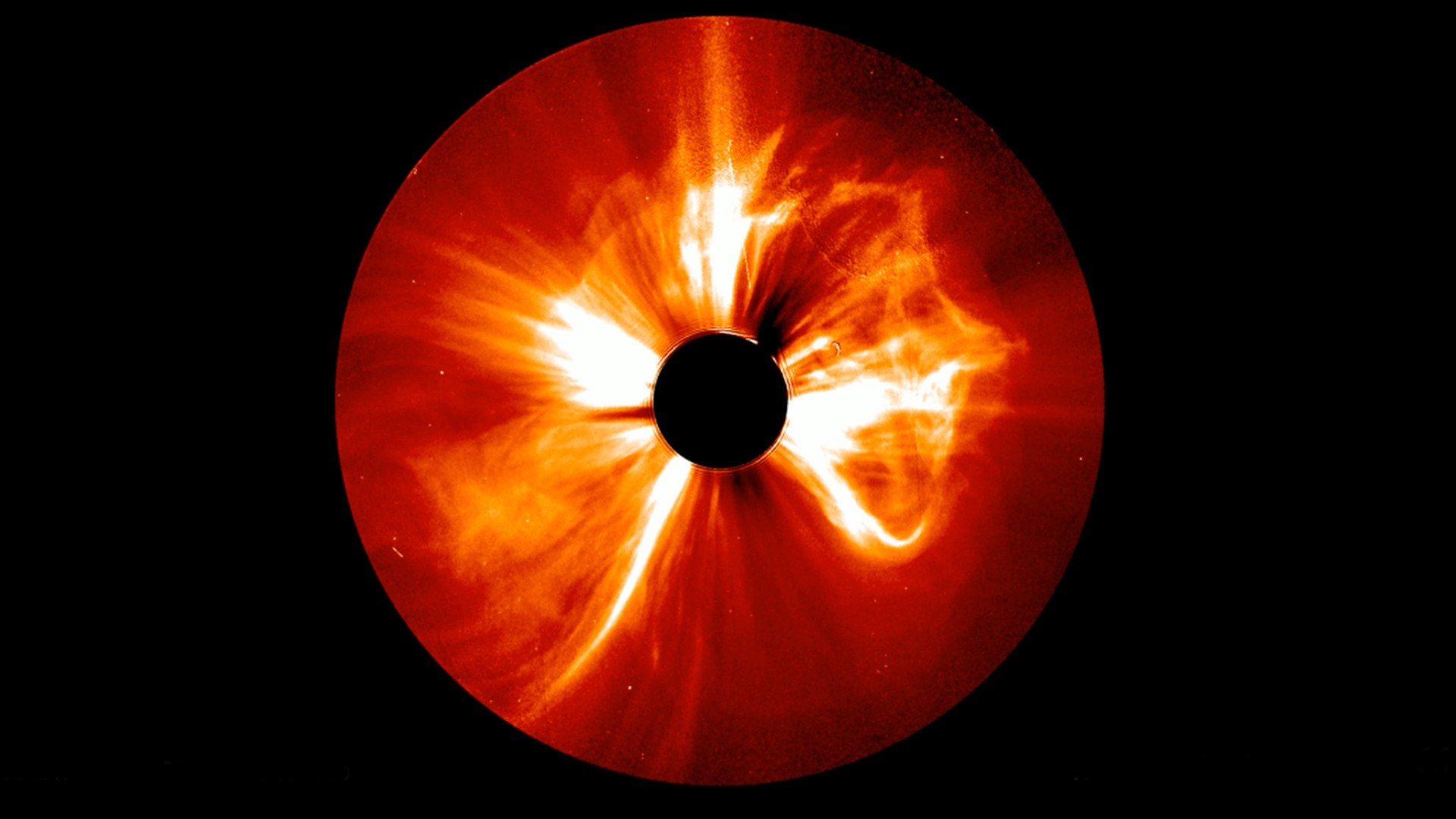 bright white tendrils of light explode outwards from a solid black circle on a red background