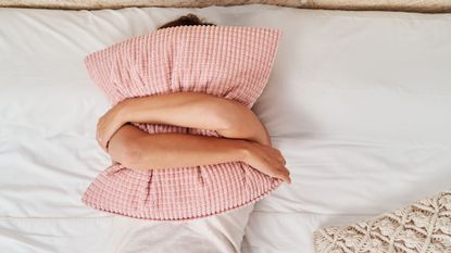 4-7-8 sleep method: A woman with a pillow over her face