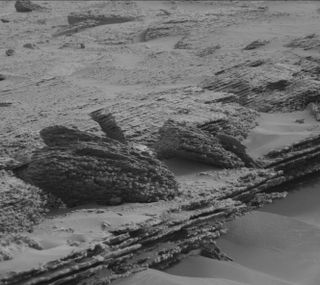 A black and white image of a section of mars with ripple patterns.