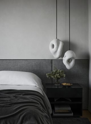 A bedroom drenched with light and dark shades of gray