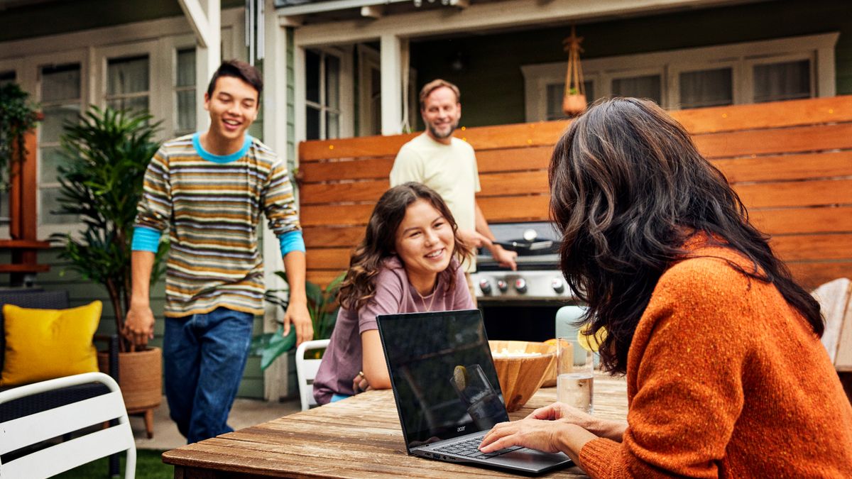 Woman using an Acer Spin chromebook at a table with friends