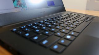 Image is a closeup of the lit-up keyboard on the Razer Blade 14.