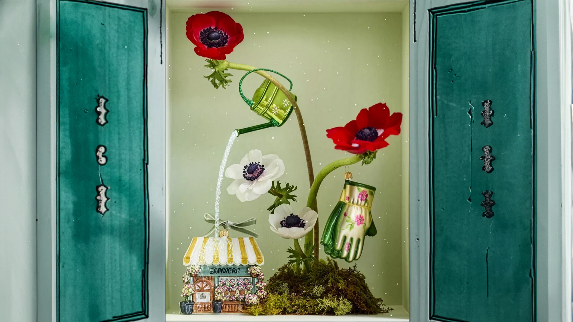 Still life display cabinet featuring garden-themed Christmas ornaments