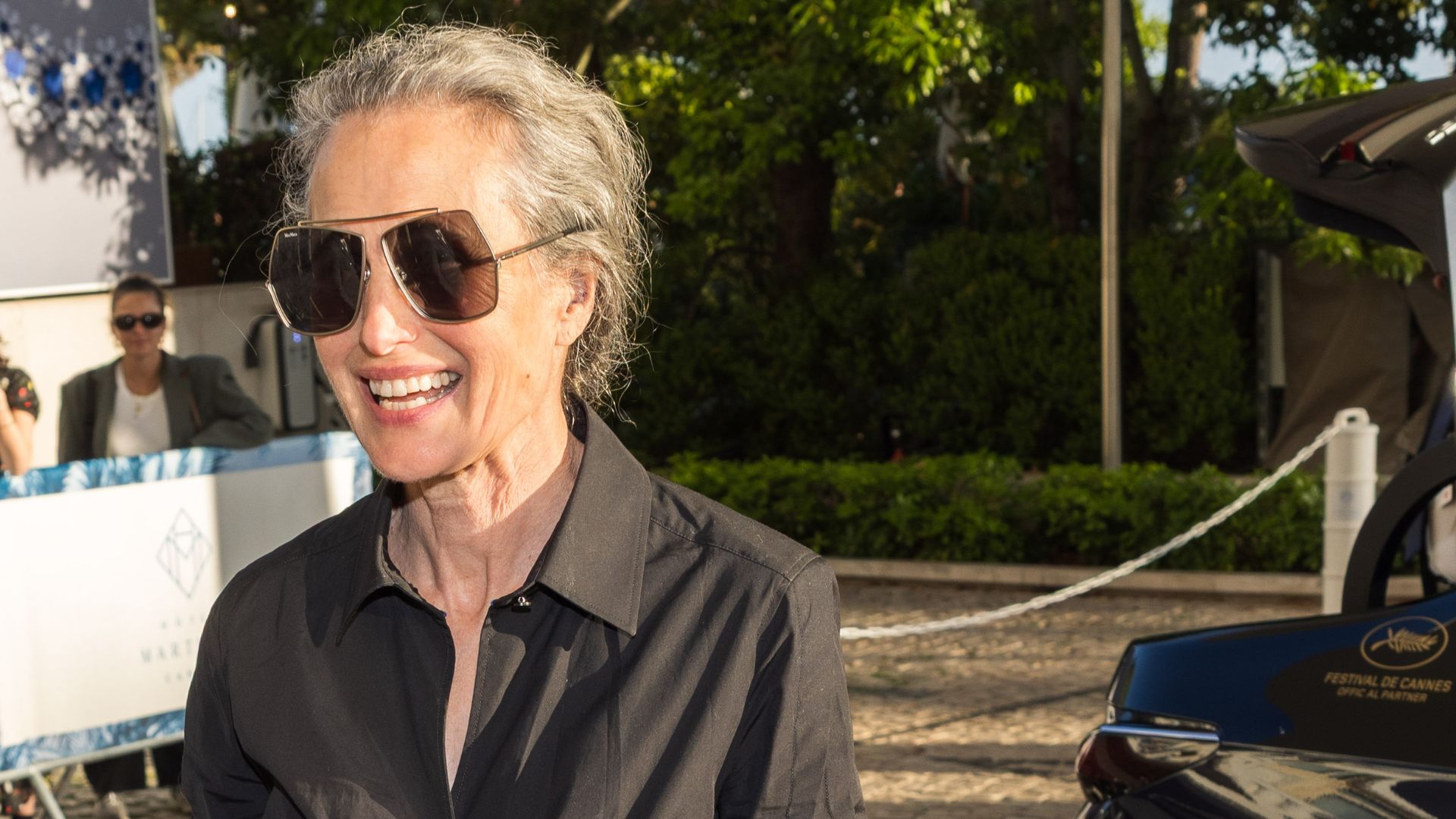 A HEADSHOT OF ANDIE MACDOWELL WEARING BLACK DRESS AND SUNGLASSES