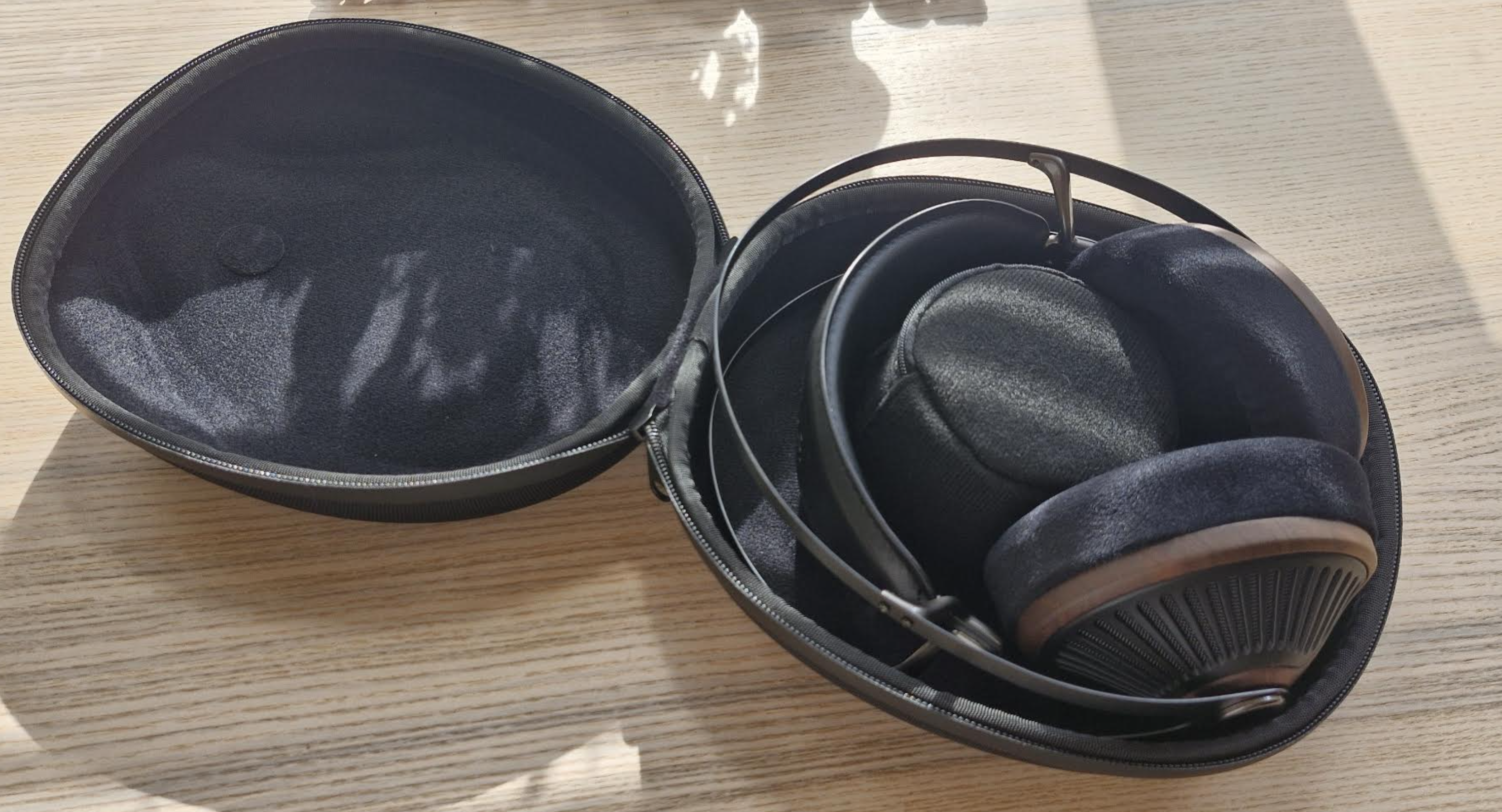 Meze Audio 105 Silva headphones on a light wooden table