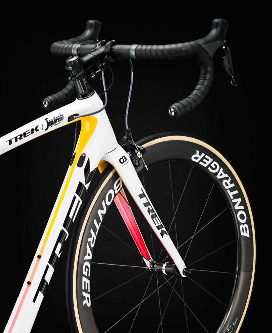 The predominantly white design features yellow, pink and red flashes representing victories at all three Grand Tours