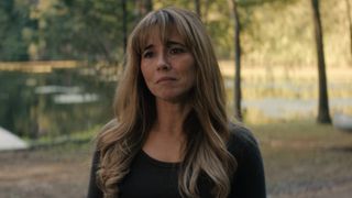 Linda Cardinelli's Pam in a black shirt with the lake in the background during Crystal Lake Episode 5. 