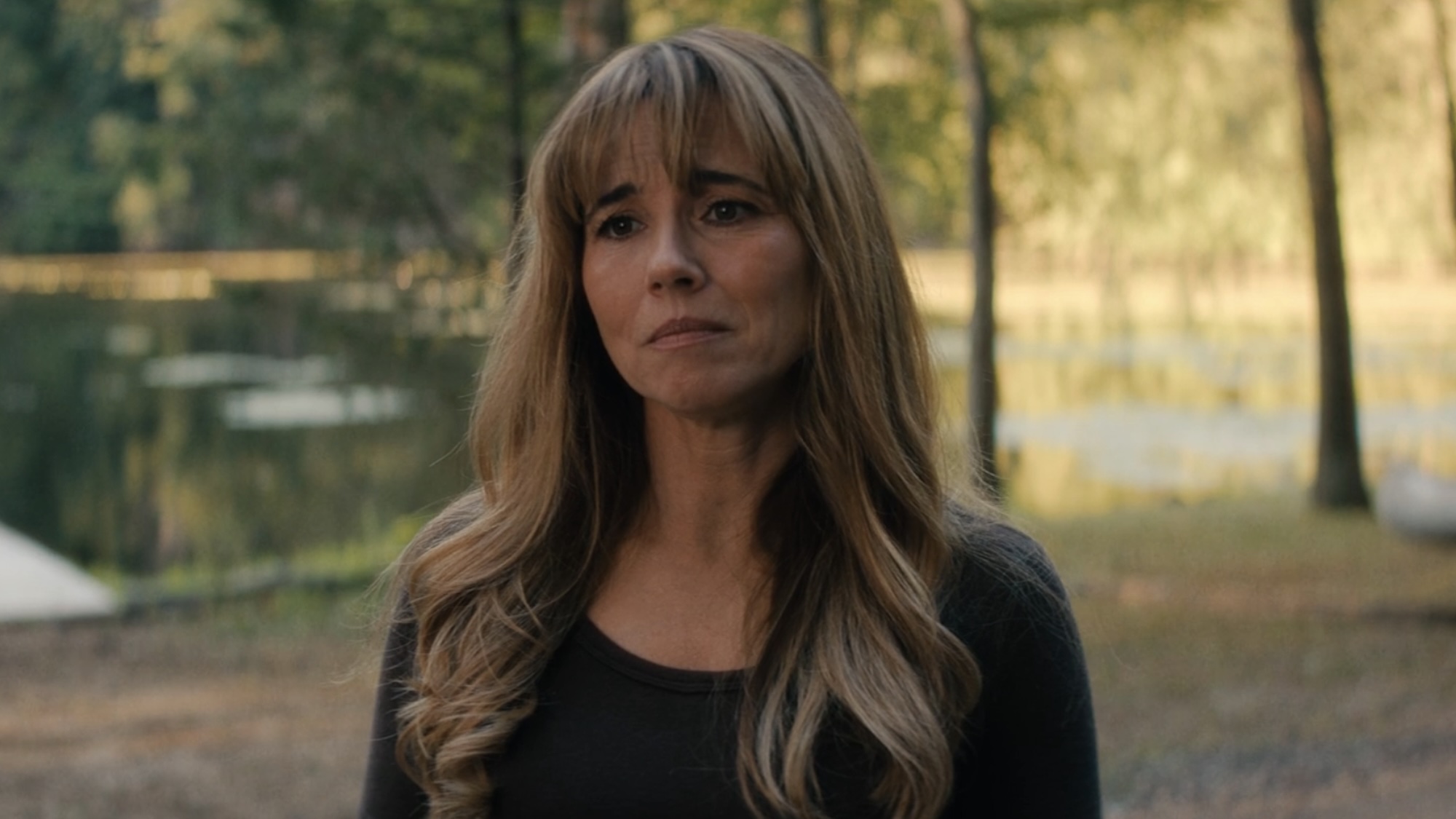 Linda Cardinelli's Pam in a black shirt with the lake in the background during Crystal Lake Episode 5. 