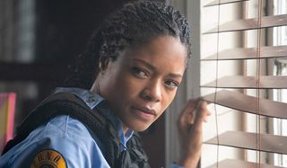 Black and Blue Naomie Harris looks back to question someone's intent