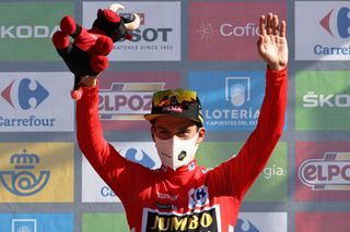 Team Jumbos Slovenian rider Primoz Roglic celebrates on the podium retaining the overall leaders red jersey after the 7th stage of the 2021 La Vuelta cycling tour of Spain a 152 km race from Gandia to Balcon de Alicante in Tibi on August 20 2021 Photo by JOSE JORDAN AFP Photo by JOSE JORDANAFP via Getty Images