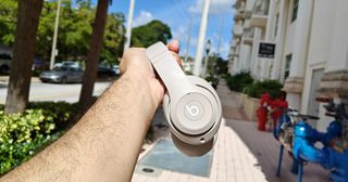 The Beats Studio Pro headphones being held in-hand