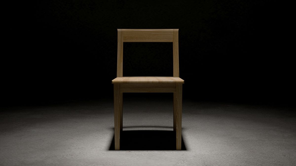 A wooden chair in a dark room. 