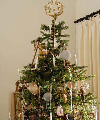 expensive looking christmas tree decorated with baubles teardrops ribbons and picture frame ornaments