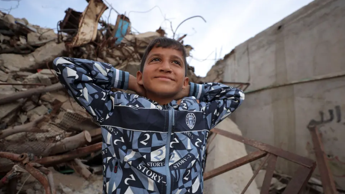 11 year old Zakaria helps paramedics bring in casualties at al-Aqsa hospital