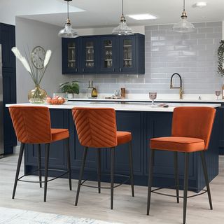 blue island with orange bar stools