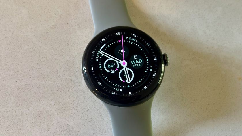 The Google Pixel Watch 3 on a white counter, showing the Field watch face.