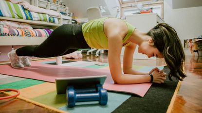 Woman taking part in an online workout at home