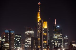 Another city wowed by the super wolf blood moon lunar eclipse. The eclipsed moon rises above the Frankfurt, Germany skyscrapers and the Commerbank headquarters, while it steps into the shadow of the Earth.