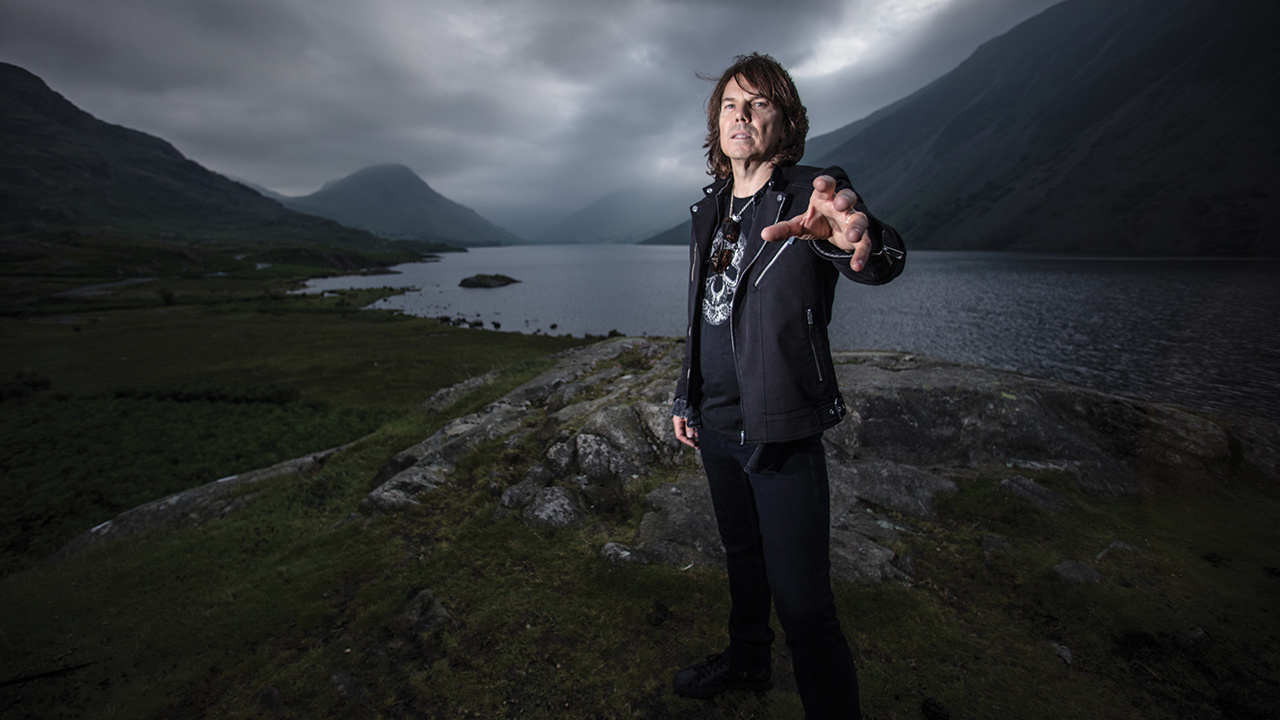 a shot of joey tempest stood on a moody hillside