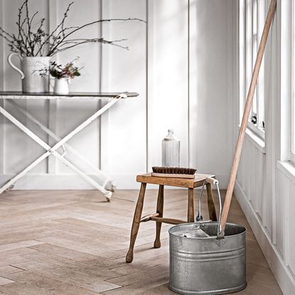 room with white walls wooden flooring and wooden table