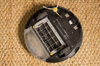 Turn the Roomba over, and you'll see treaded tires and one spinning brush, as well as the amount of material that's in its dustbin.