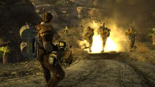 Fallout: New Vegas screenshot showing a a man with short brown hair wielding a massive flame thrower, setting three enemies in the distance ablaze with the weapons