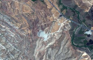 This satellite image was taken on July 31, 2019 by the WorldView-2 satellite. The red arrows show a surviving section of the Gawri Wall.