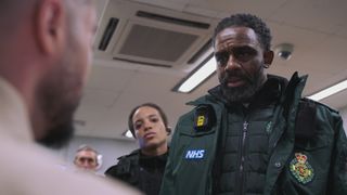 Paramedic Jacob Masters treats prisoner Caleb at the police station as police officer Steph looks on.