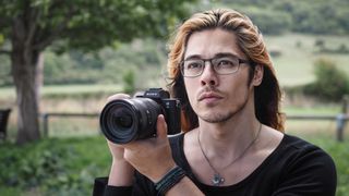 Reviewer holding Sony A7 III