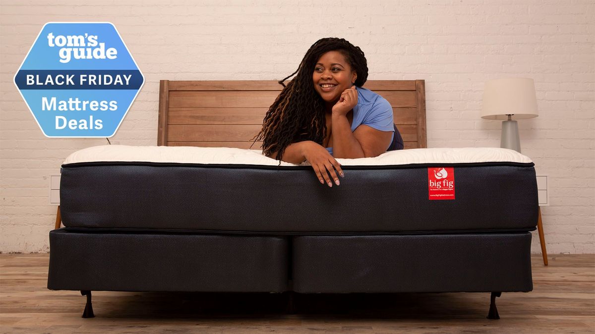 A woman lying on her front on the Big Fig mattress smiling