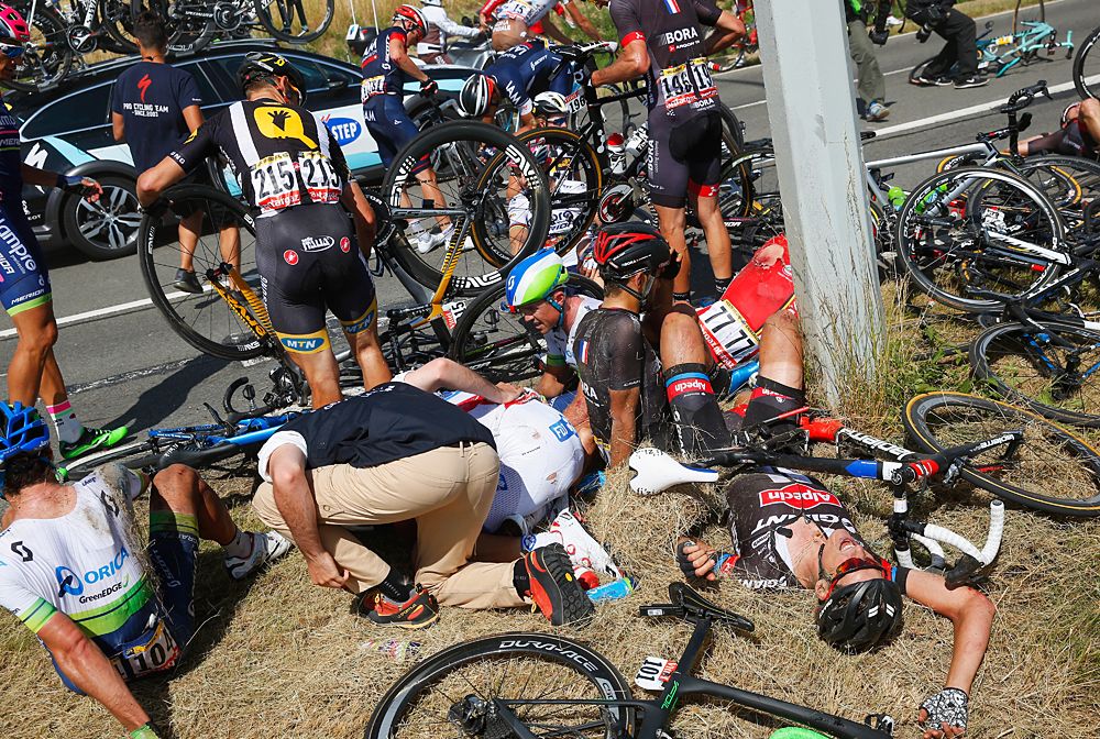 Riders and bikes are strewn across the roadside following a crash near Brabant Wallon during stage 3 of the 2015 Tour de France