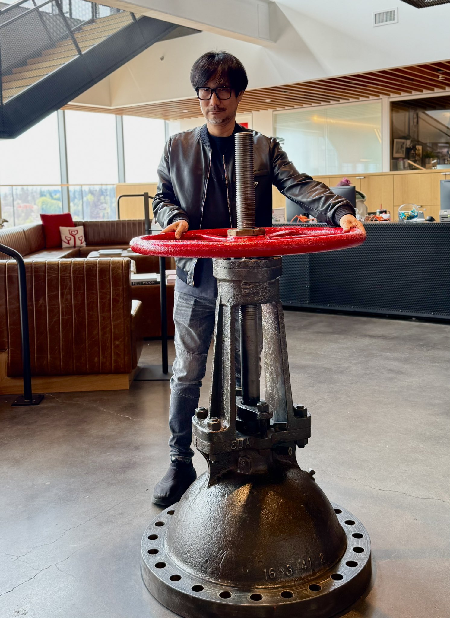 Hideo Kojima poses with various objects at Valve Software's offices.