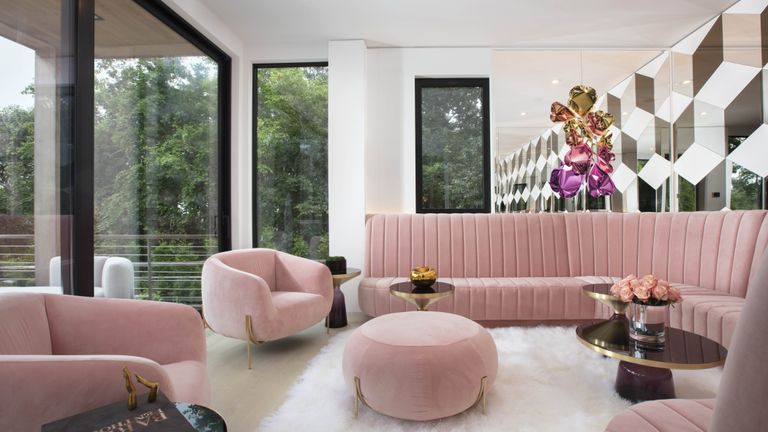 Florida style living room with pink sofas and white rug