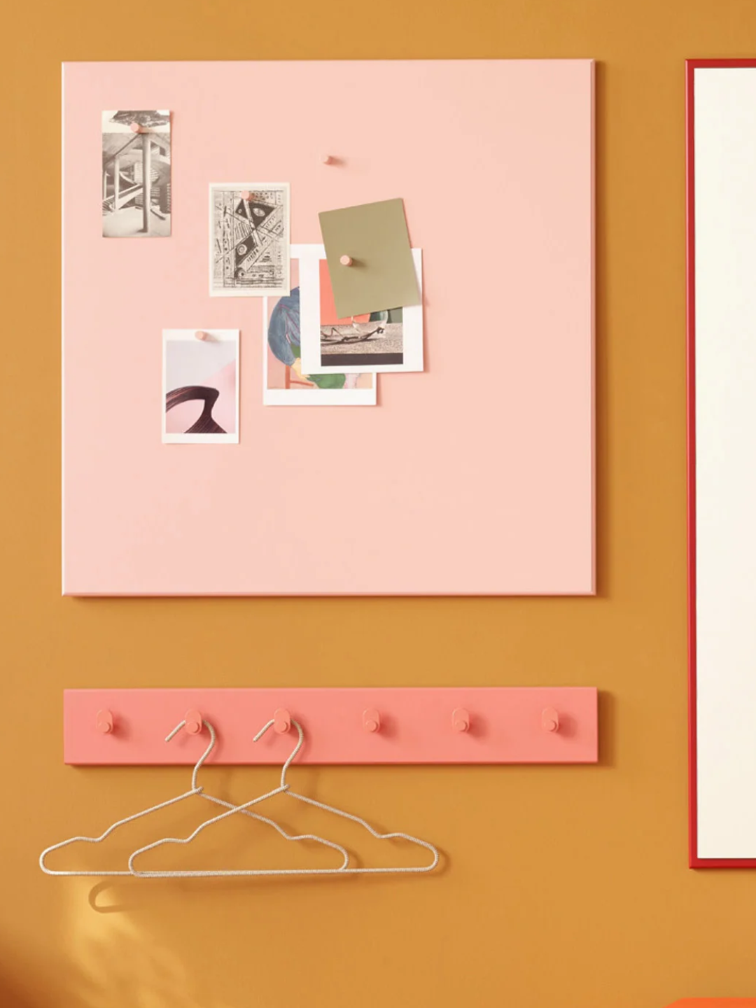 A light pink noticeboard with magnets from Montana Furniture
