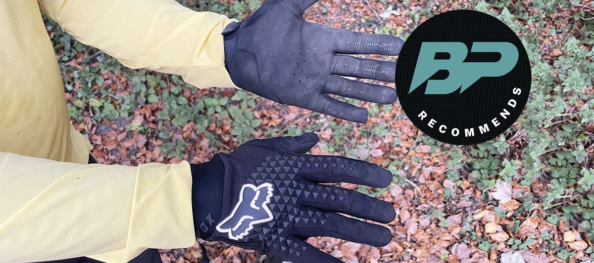 Fox Defend Gloves worn with leafy trail backdrop