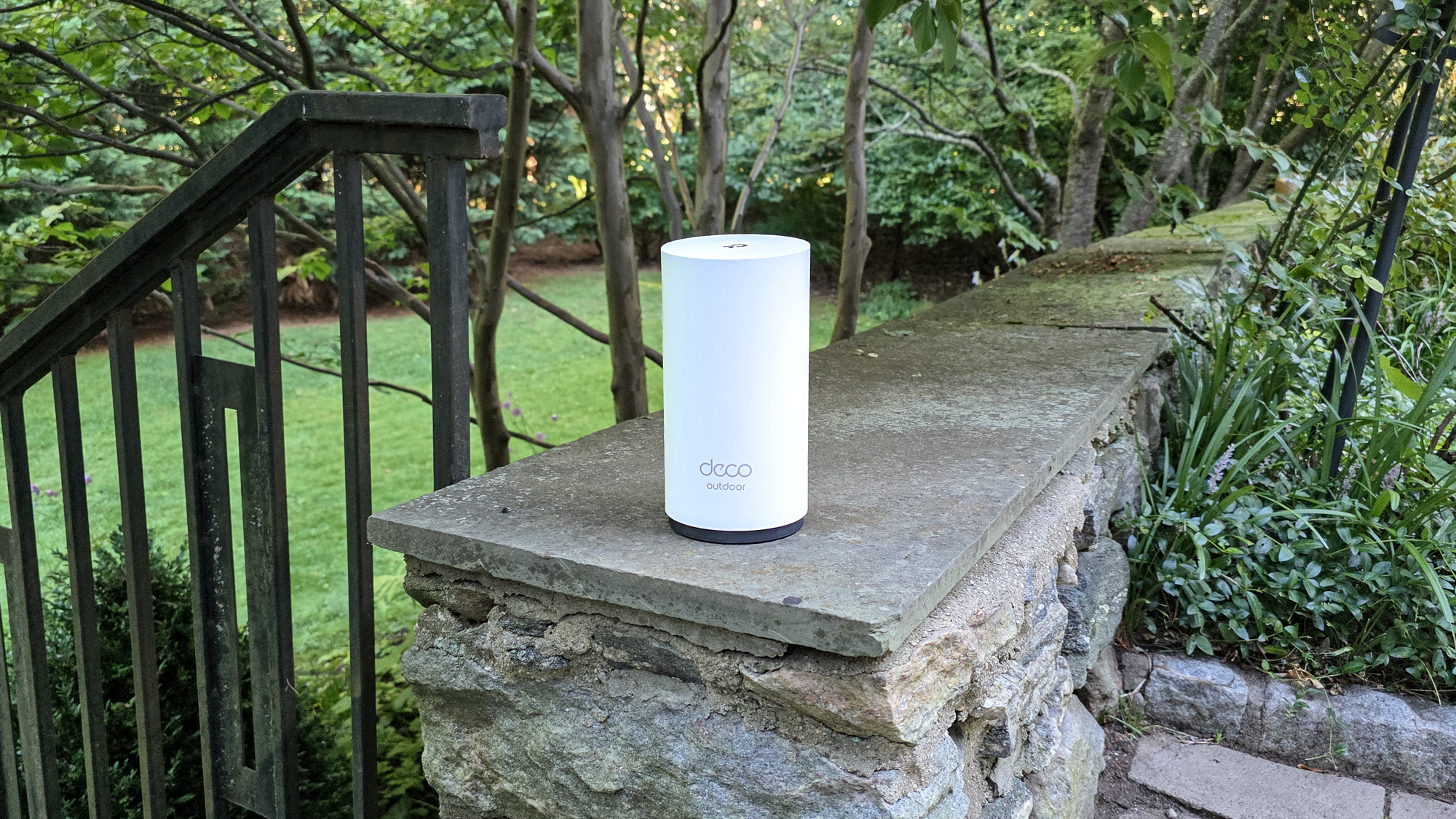 TP-Link Deco BE65-Outdoor on a garden wall