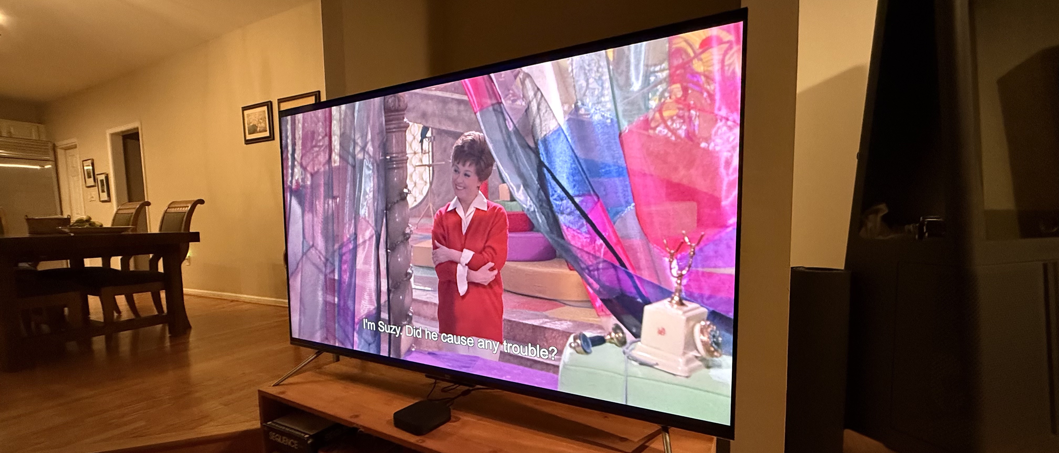 Amazon Fire TV Omni QLED (2025)on stand showing colorful image