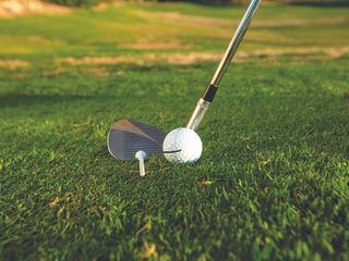 Golf ball line up at the heel of the club, with a tee in front of the centre of the clubface as part of a drill