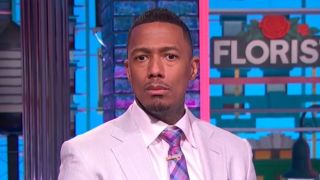 Nick Cannon hosting talk show in light purple suit