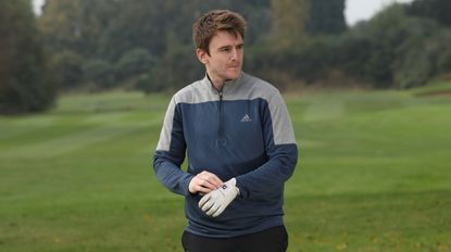 adidas lightweight 1/4 zip sweatshirt, man putting golf glove on