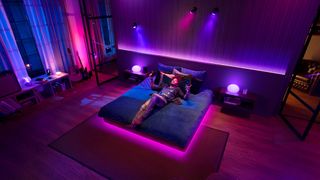 Philips Hue + Spotify lighting up a bedroom in pink and purple lights