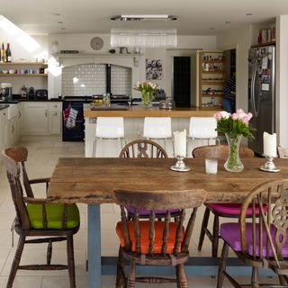 open plan kitchen with brown dining table and black aga