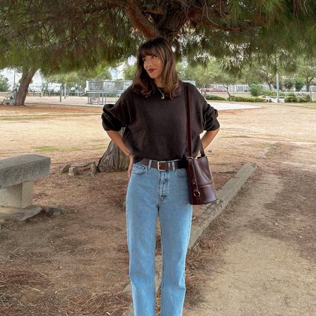French influencer wearing jeans and a sweater